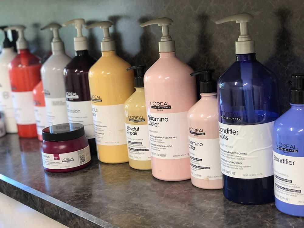 A row of assorted L'Oréal Professional hair care bottles on a counter.